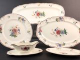 three plates and a saucer on a table