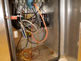 a metal box with a bunch of wires inside of it