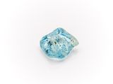 a close up of a piece of blue glass on a white surface