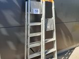 a ladder leaning against a wall next to a building