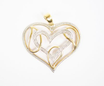 a gold and diamond heart pendant on a white background