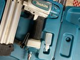 a blue box with a stapler and a stapler in it
