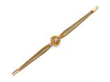 an 18k yellow gold bracelet with a flower clasp