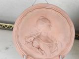 a pink plate with a picture of a child on it
