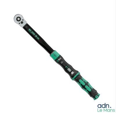 a close up of a wrenet with a green handle