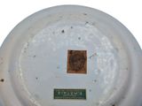 a white plate with a brown label on it