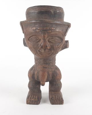 an old wooden statue of a man with a hat on his head