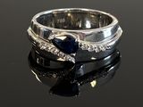 a close up of a ring on a table with a black background