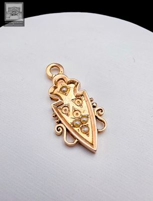 an image of a gold plated pendant with a bird on it