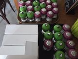 a table with a bunch of green and purple apples on it