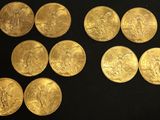 six different types of gold coins on a black surface