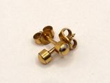 a close up of a pair of gold colored screws on a white surface