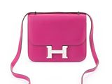 a pink purse with a metal handle on a white background