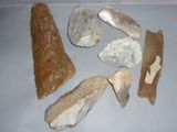 five different types of stone tools on a white surface