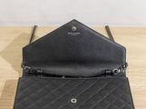 a black purse sitting on top of a wooden table
