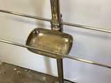 a metal stand with a soap dish on top of it
