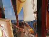 a picture of a picture of a woman on a boat and a picture of a man on a sailboat