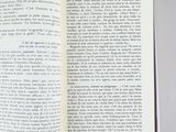 an open book on a table with a pen and paper in it