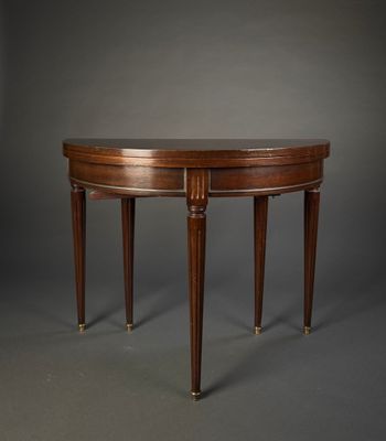 an oval mahogany table with two legs and a wooden top