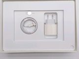 a white box with a charger and a cable in it