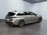 the rear end of a silver car in a white room
