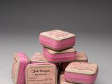 six pink soap bars stacked on top of each other on a table