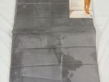 a close up of a towel on a bed with a tag on it
