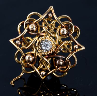 an image of a gold and diamond ring on a black surface