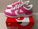 pink and white nike dunk dunk low sneakers on top of a box
