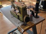 a sewing machine that is sitting on a table in a room