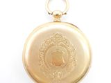 an image of a gold pocket watch sitting on a white surface