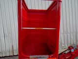 a red hand truck that is parked in front of a building