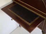 a small wooden desk with a drawer underneath it