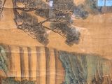 a cat that is standing in front of a painting