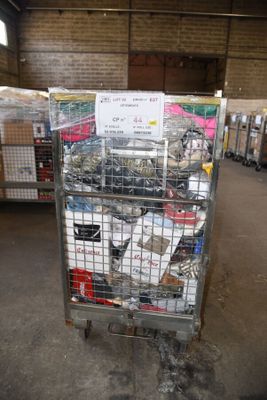 a metal cart with many items in it in a warehouse