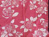 a pink scarf with white flowers on it