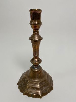 a metal candle holder on a white background