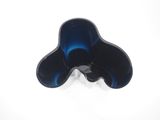 a black and blue flower shaped object on a white surface