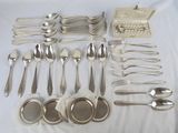 a lot of silver spoons and spoons on a table