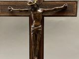 a close up of a wooden cross with a jesus on it