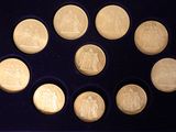 a picture of a set of twelve gold coins in a box