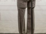 female mannequin in a white shirt and brown pants on a stand