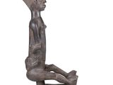 statue of a woman sitting on the ground with her legs crossed
