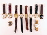 several different types of watches are arranged in a row on a white surface