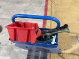 a blue cart with tools in it sitting on the sidewalk