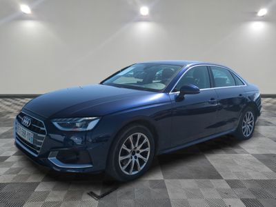 a blue audi sedan parked on a checkered tile floor