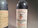 two bottles of wine sitting next to each other on a table
