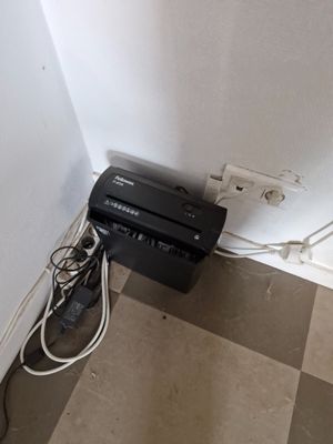 an image of a tv and a printer in the corner of a room