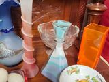 a wooden table with plates, bowls, and vases on it