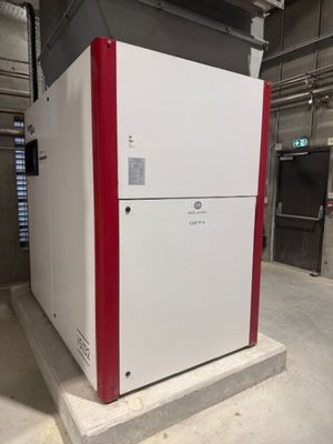 a white refrigerator with red trims in a building